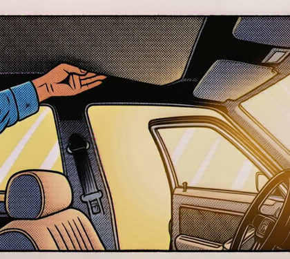 A hand lifting the fabric headliner inside a sunlit car with the door open